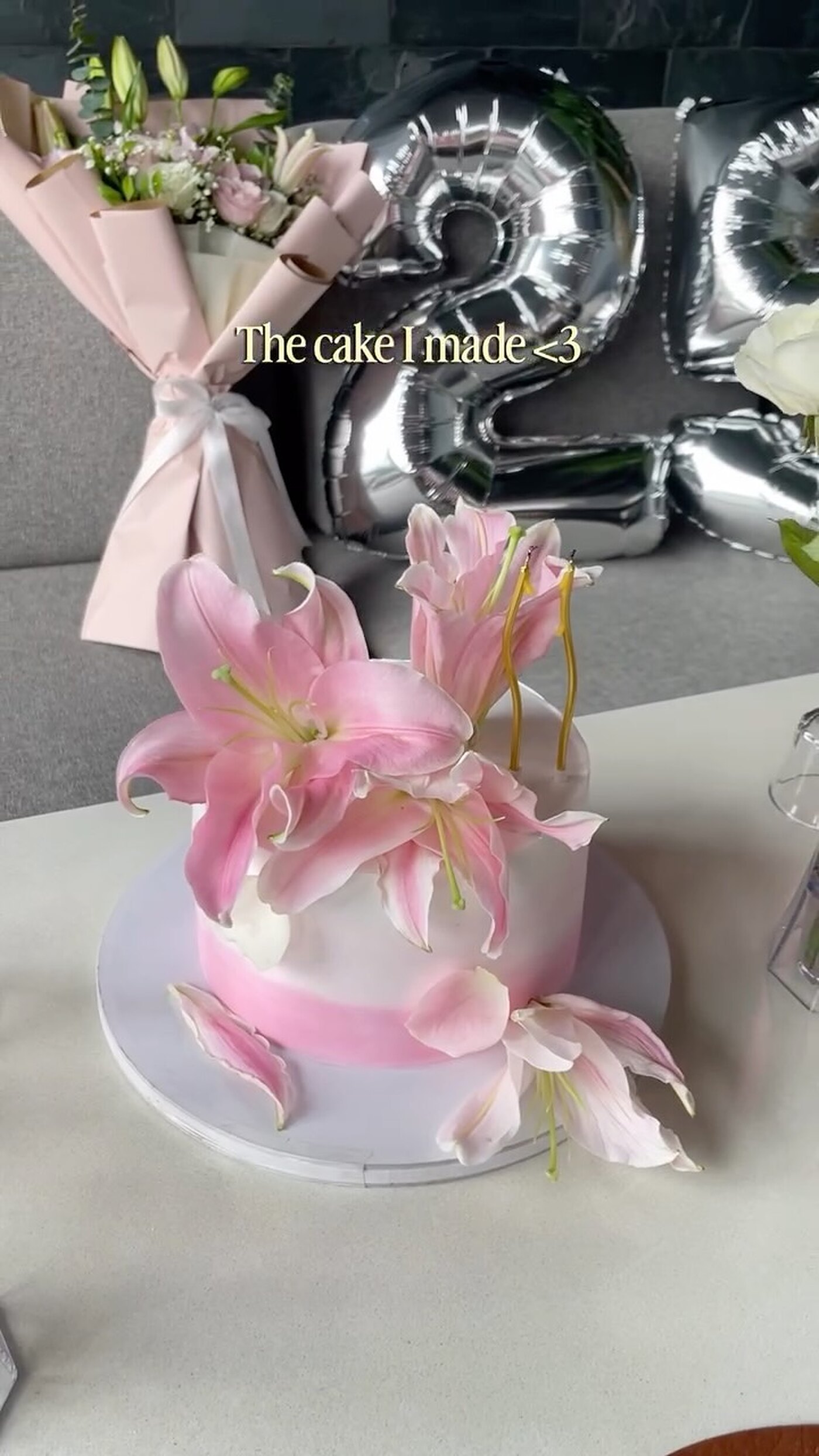 Lily-topped cake with number balloons